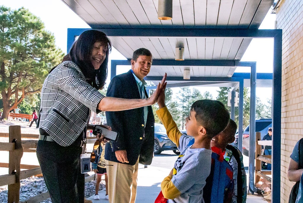 Superintendent Haberer high-fives a student at Douglass Valley Elementary School.